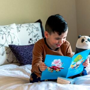 Young child exploring an illustrated picture book while practising early reading skills.